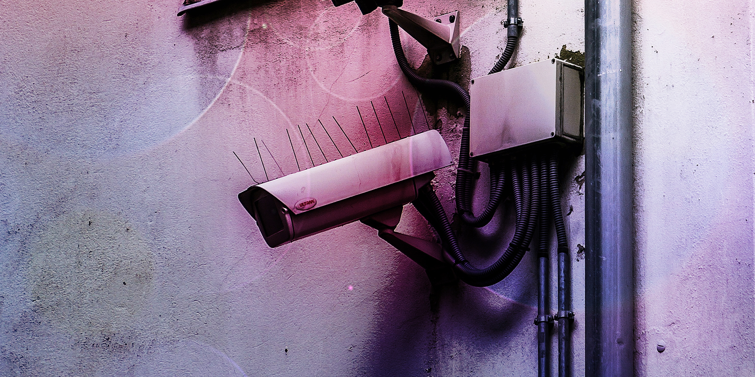 A surveillance camera on an exterior wall.
