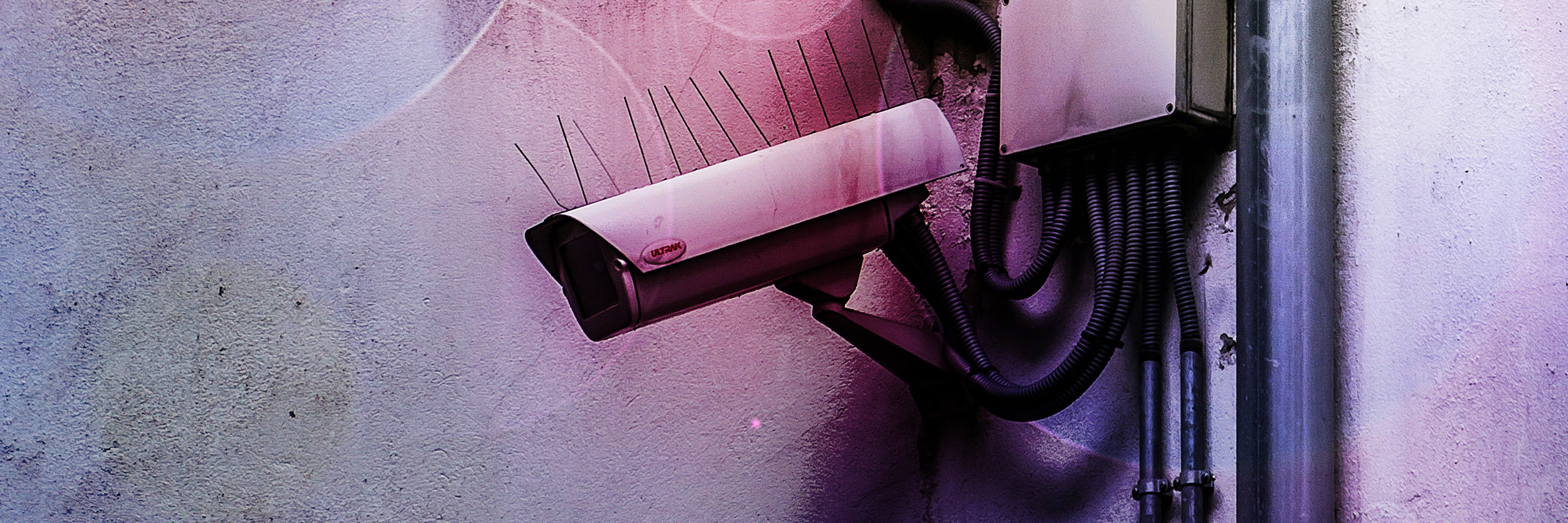 A surveillance camera on an exterior wall.